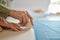 Dressmaker measures cloth on the table in workshop