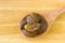 Dried Amla Indian gooseberry fruit in wood spoon on wooden background