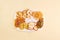 Dried apple, pear, pineapple,kiwi,apricot, coconut, orange and mandarin chips on plate on yellow background.