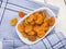 Dried apricots in bowl on table, high angle view