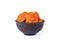 Dried apricots in a brown clay bowl isolated on a white background. Front view