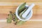 Dried bay leaves and allspice in kitchen mortar, top view