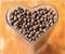 dried berries coffee beans on shaped heart bottle