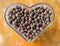 dried berries coffee beans on shaped heart bottle