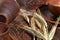 Dried bread spikes with ceramic bowls and mug on a brown wooden table. Autumn harvest of bread