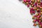 Dried buds of a tea rose on a shabby wooden table. flat lay