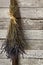 A dried bunch of lavender flowers hanging up on an old textured wooden wall