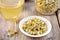 Dried camomile flowers on saucer.