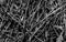 Dried cane branches, background texture, black faded bamboo, old felled cane, close-up, black and white photograph, beveled stems