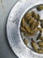 Dried cardamom placed spreaded on a plate.