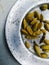 Dried cardamom placed spreaded on a plate.