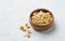 Dried chamomile in a wooden bowl on a light background. Healthy food and drink concept. Herbal and alternative medicine with dry