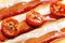 Dried cherry tomatoes with bacon. Selective focus. Close up view