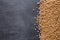 Dried chickpeas on dark surface with border