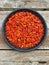 Dried Chili Peppers in a Tampah. Natural foods. Natural cooking. Natural spices. Close-up. From above