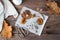 Dried chopped fly agarics stacked in a small jar and dry mushrooms on parchment and scissors on a wooden table. Microdosing and