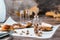 Dried chopped fly agarics stacked in a small jar and dry mushrooms on parchment on a wooden table. Microdosing and Alternative