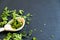 Dried cilantro leaves on a wooden spoon. Natural light. Selective focus. Close up on a black background. Top view, flat