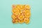 Dried citrus slices lemons & oranges on turquoise colored background