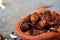 Dried coccinia grandis in the red clay pot. it is also know as Mithuku Vathal