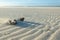 Dried coconut splitted in two over the sand