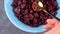 Dried cranberries in blue bowl top view. Organic nutritious Healthy tasty dry red berries spoon