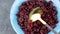 Dried cranberries in blue bowl top view. Organic nutritious Healthy tasty dry red berries spoon