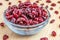 Dried cranberries in bowl up-close on wood