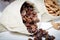 Dried currants in hessian bag on white wooden table