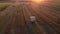 Dried cut straw in large round bales on field after mowing and harvesting wheat