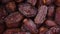 Dried date fruit rotatation. Dried fruits background. Fresh sweet dates, organic food. Food ingredient background. Vegan