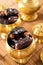 Dried date fruits in golden metal bowl.