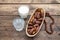 Dried dates fruits on a branch, a glasses of water and milk on a wooden table