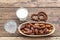 Dried dates fruits on a branch, a glasses of water and milk on a wooden table