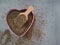 Dried, dehydrated oregano (Origanum vulgare) in a heart-shaped bowl