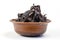 Dried dog treats in a brown clay bowl on a white background. Thin slices of dehydrated beef heart