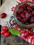 Dried dogwood (cornelian cherry berry) in jar on wooden background