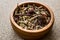 Dried Echinacea Purpurea Root in wooden bowl.