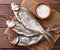 Dried fish with hodgepodge on a wooden background. The view from top