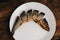 dried fish on a plate beer snack snack wooden table