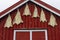 Dried fish on a wall of a little red painted cottage