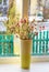 Dried flowers in vase on a window against winter background