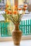 Dried flowers in vase on a window against winter background