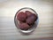 Dried fragrant nutmeg seeds in glass bowl