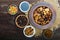 Dried fruit apples, pears, apricot, berries, walnut kernels, raisins, poppy seeds in a bowl on dark wooden background.