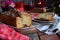 Dried fruit cake with raisins, apricots, cherry and glass of red wine, bottle and flower rustic wooden background. Valentines day