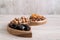 Dried fruit and nuts in a wooden bowls on the table. Wave shape.