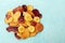 Dried fruit and vegetable chips, healthy vegan snack, a mixed heap on a teal background