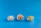 Dried fruits in assortment  in glass cups on a blue background. The concept of a healthy lifestyle