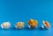 Dried fruits in assortment  in glass cups on a blue background. The concept of a healthy lifestyle